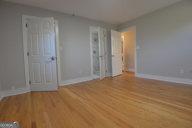 2647 Mount Carmel Rd, Hampton, GA 30228 - unfurnished bedroom featuring baseboards, ensuite bathroom, and light wood finished floors