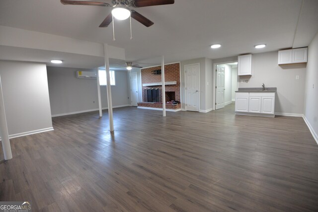 2647 Mount Carmel Rd, Hampton, GA 30228 - below grade area featuring ceiling fan, a fireplace, dark wood finished floors, baseboards, and a wall mounted AC