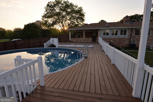 2647 Mount Carmel Rd, Hampton, GA 30228 - pool at dusk with fence, a fenced in pool, and a wooden deck
