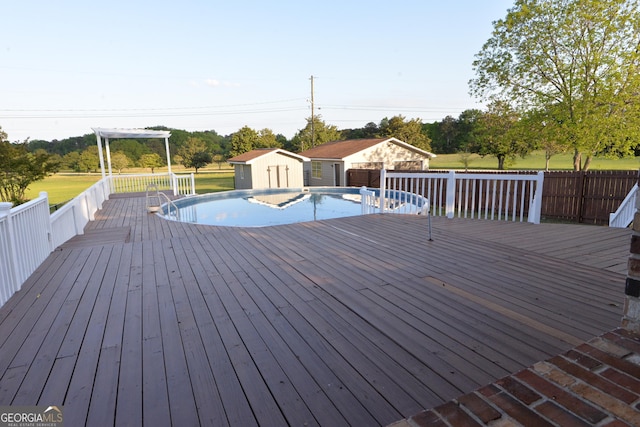 2647 Mount Carmel Rd, Hampton, GA 30228 - wooden terrace with an outdoor pool, a shed, and an outbuilding