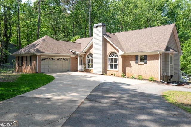 320 Williamsburg Cir, Mcdonough, GA 30253 - single story home with concrete driveway, brick siding, an attached garage, and a chimney