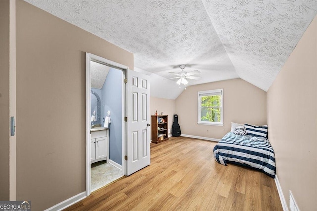 320 Williamsburg Cir, Mcdonough, GA 30253 - bedroom with a textured ceiling, baseboards, lofted ceiling, and light wood-type flooring