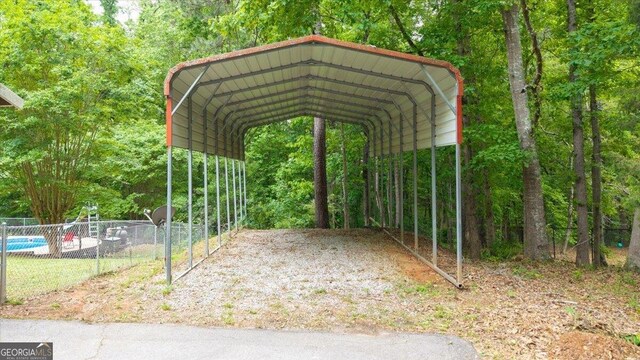 320 Williamsburg Cir, Mcdonough, GA 30253 - view of car parking featuring fence and a carport