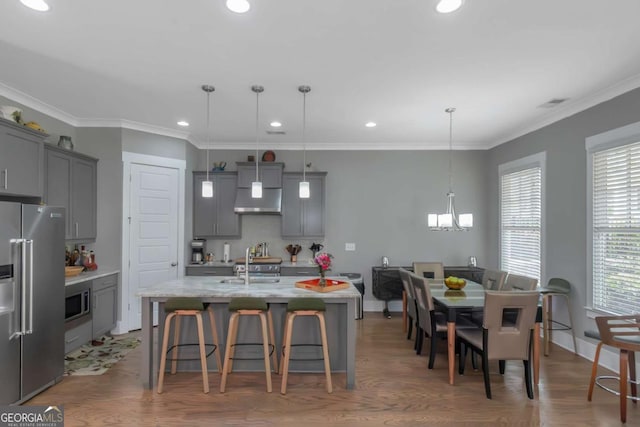 1914 Coal Pl, Atlanta, GA 30318 - kitchen featuring a breakfast bar, a chandelier, an island with sink, gray cabinets, and stainless steel appliances