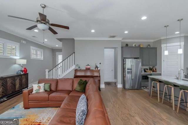 1914 Coal Pl, Atlanta, GA 30318 - living area featuring ceiling fan, recessed lighting, light wood-type flooring, ornamental molding, and stairway