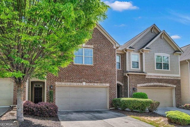 view of property featuring concrete driveway, brick siding, and an attached garage