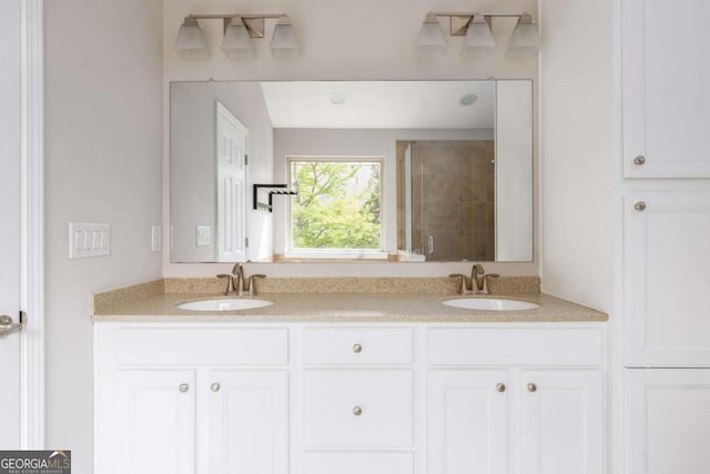 full bath with double vanity, a sink, and a stall shower
