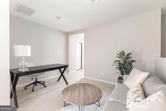 office space with carpet floors, baseboards, and visible vents