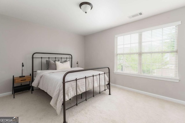carpeted bedroom with baseboards and visible vents