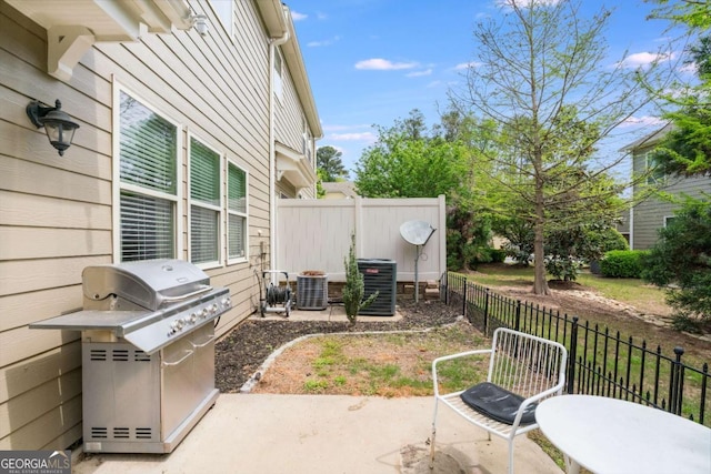 view of patio / terrace with grilling area, central AC, and fence