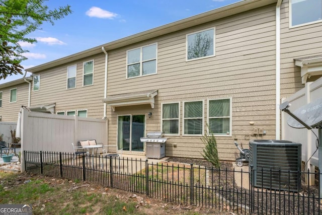 back of property with a patio, central AC unit, and fence