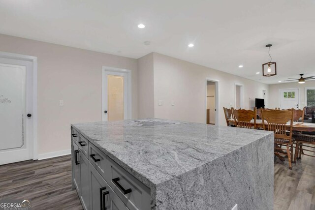 235 Holly Rd NW, Atlanta, GA 30314 - kitchen featuring a ceiling fan, dark wood-style flooring, pendant lighting, light stone countertops, and recessed lighting