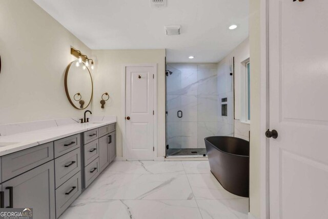 235 Holly Rd NW, Atlanta, GA 30314 - bathroom featuring double vanity, a shower stall, a sink, marble finish floor, and a soaking tub
