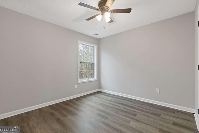 7074 Ravenwood Ln, Lithonia, GA 30038 - unfurnished room with baseboards, a ceiling fan, dark wood finished floors, and visible vents