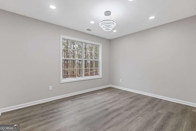 7074 Ravenwood Ln, Lithonia, GA 30038 - empty room featuring baseboards, dark wood-style floors, a chandelier, and visible vents