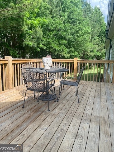 wooden terrace with outdoor dining space