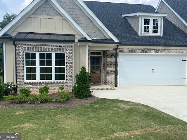 craftsman-style home featuring concrete driveway, brick siding, a shingled roof, and a garage