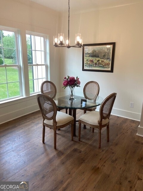 dining room with baseboards, dark wood finished floors, and an inviting chandelier