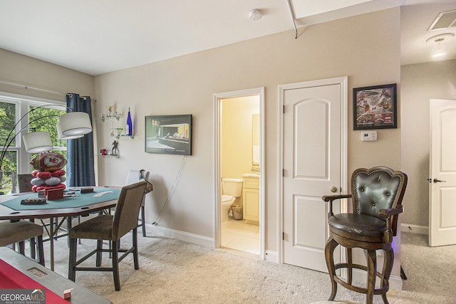 dining room with light colored carpet, baseboards, and visible vents