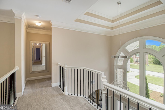 hallway with crown molding, visible vents, an upstairs landing, and carpet