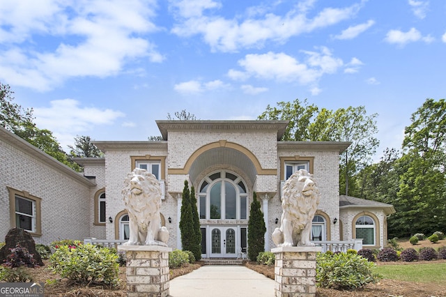 view of front of property featuring brick siding and french doors