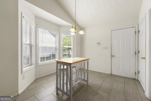 1395 Brisbane Dr, Dacula, GA 30019 - dining space with a chandelier, a textured ceiling, baseboards, and wood tiled floors