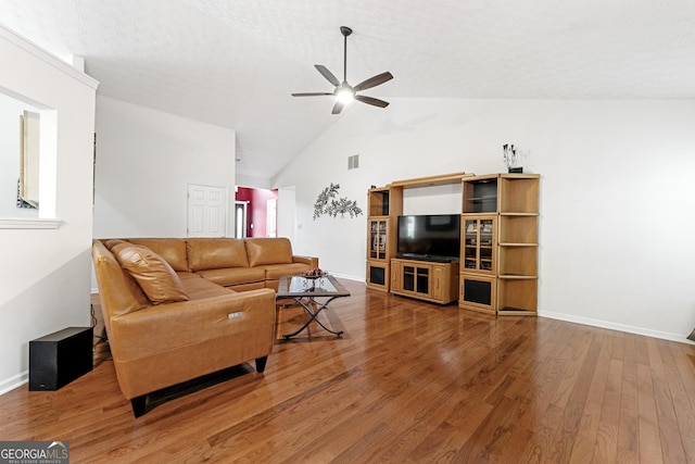 1395 Brisbane Dr, Dacula, GA 30019 - living room featuring ceiling fan, wood finished floors, baseboards, and high vaulted ceiling