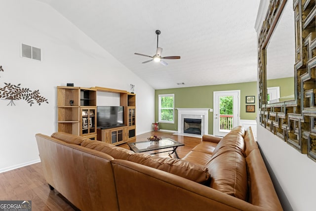 1395 Brisbane Dr, Dacula, GA 30019 - living area featuring a ceiling fan, wood finished floors, a premium fireplace, baseboards, and high vaulted ceiling