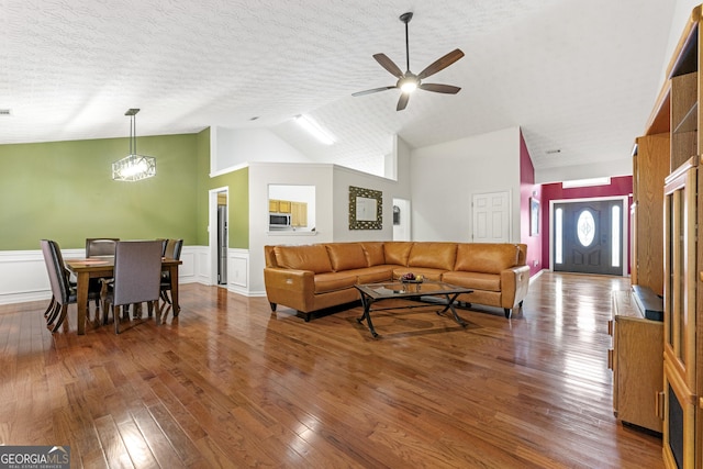 1395 Brisbane Dr, Dacula, GA 30019 - living area with hardwood / wood-style floors, ceiling fan, a wainscoted wall, high vaulted ceiling, and a textured ceiling