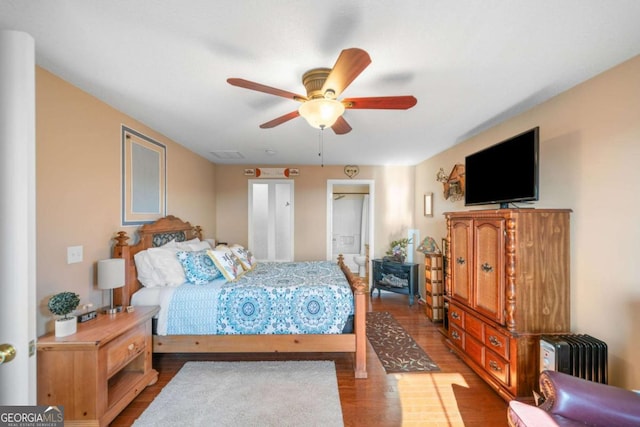 bedroom featuring visible vents, a ceiling fan, and wood finished floors