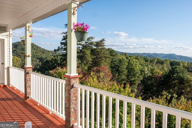 exterior space with a view of trees and covered porch