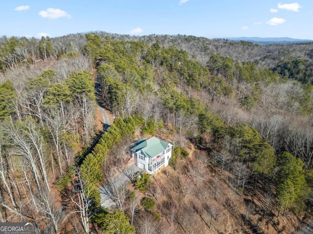 drone / aerial view featuring a wooded view
