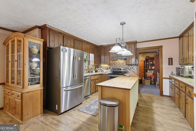 3876 Winners Ct, Marietta, GA 30062 - kitchen featuring stainless steel appliances, wooden counters, ornamental molding, light wood finished floors, and under cabinet range hood
