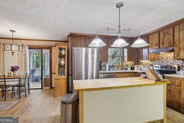 3876 Winners Ct, Marietta, GA 30062 - kitchen featuring under cabinet range hood, butcher block countertops, stainless steel appliances, a kitchen island, and backsplash