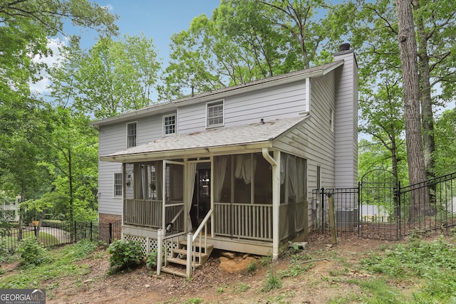 3876 Winners Ct, Marietta, GA 30062 - rear view of house with a sunroom, a chimney, and brick siding