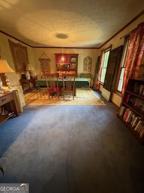 dining room featuring crown molding, dark carpet, and a textured ceiling