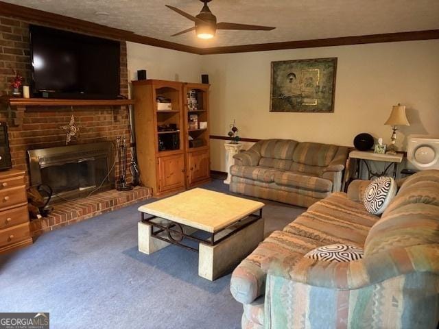 living area with a ceiling fan, carpet flooring, a brick fireplace, ornamental molding, and a textured ceiling
