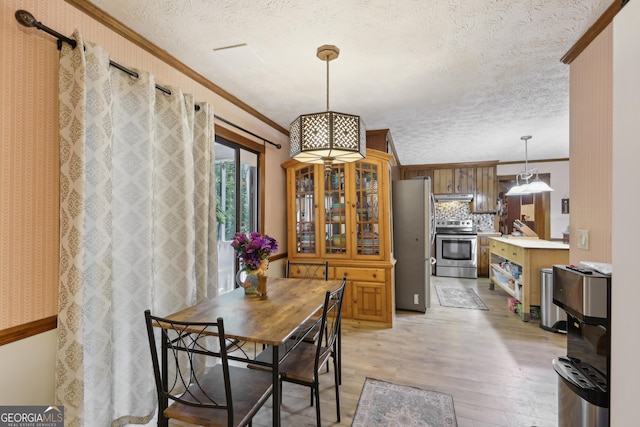 3876 Winners Ct, Marietta, GA 30062 - dining area with a textured ceiling, ornamental molding, light wood-type flooring, and a chandelier