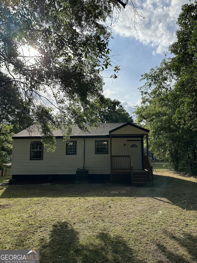 rear view of house with a lawn