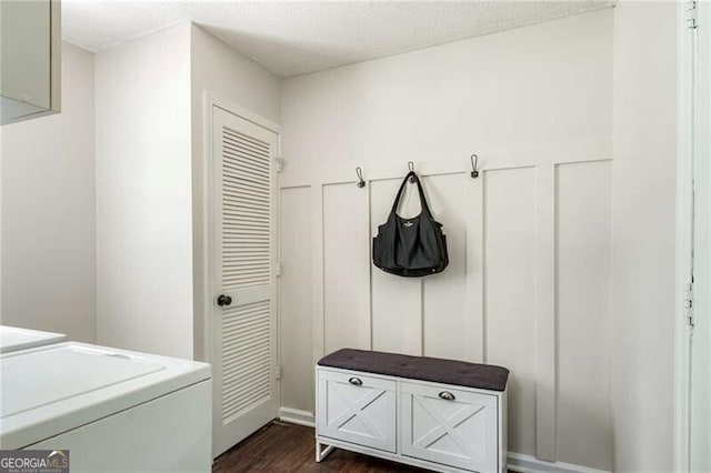 mudroom featuring separate washer and dryer, dark wood finished floors, and a textured ceiling