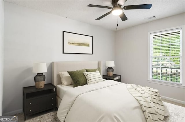 bedroom with baseboards, carpet floors, visible vents, and multiple windows