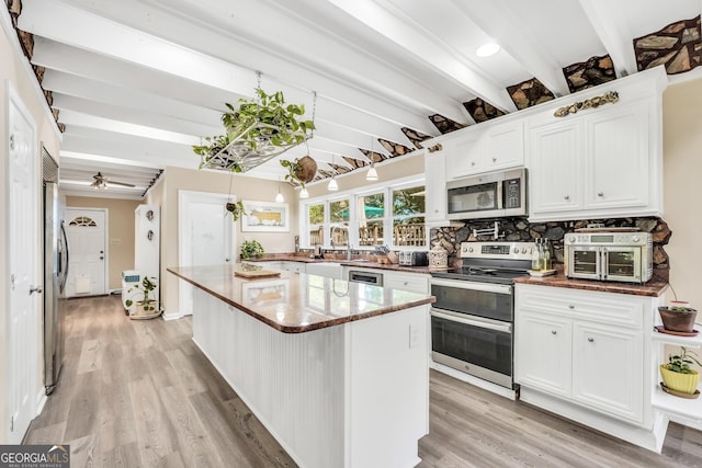 701 Mask Rd, Brooks, GA 30205 - kitchen featuring appliances with stainless steel finishes, light wood-style flooring, and beam ceiling