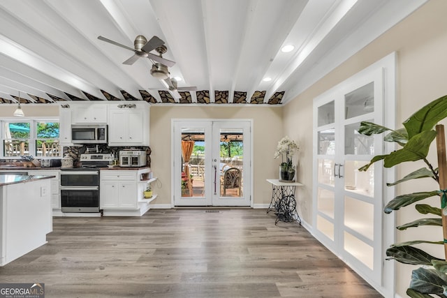 701 Mask Rd, Brooks, GA 30205 - kitchen with beam ceiling, ceiling fan, white cabinetry, french doors, and stainless steel appliances