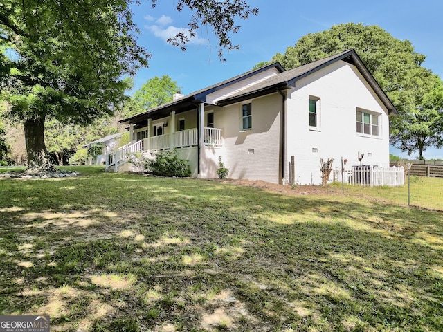 701 Mask Rd, Brooks, GA 30205 - exterior space with fence, a front yard, a chimney, and covered porch