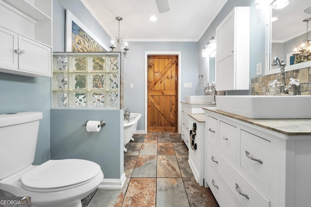 701 Mask Rd, Brooks, GA 30205 - full bathroom featuring stone tile flooring, toilet, a freestanding bath, a chandelier, and tasteful backsplash