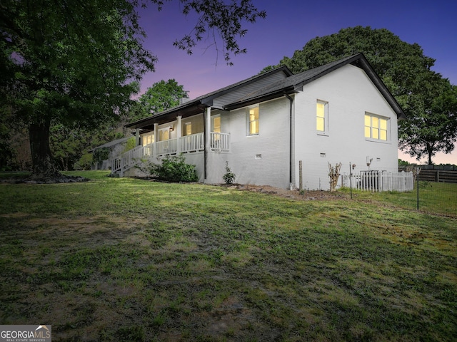 701 Mask Rd, Brooks, GA 30205 - view of side of home with fence, covered porch, a yard, and brick siding