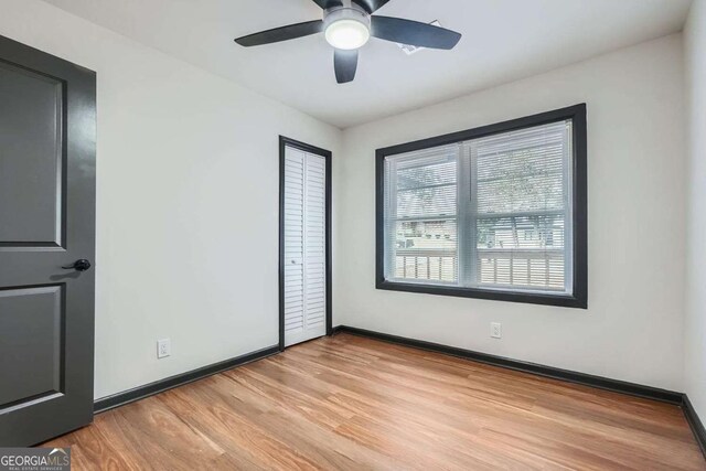 2091 Parker Ranch Rd SE, Atlanta, GA 30316 - unfurnished bedroom featuring light wood-style floors, baseboards, and a ceiling fan