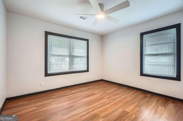 2091 Parker Ranch Rd SE, Atlanta, GA 30316 - unfurnished room featuring visible vents, a ceiling fan, light wood-style floors, and baseboards