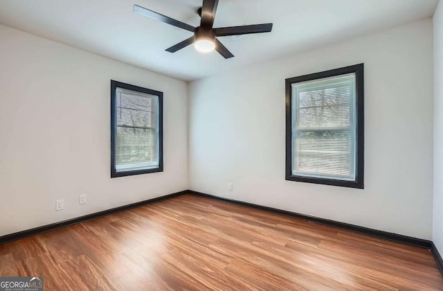 2091 Parker Ranch Rd SE, Atlanta, GA 30316 - empty room featuring baseboards, a ceiling fan, wood finished floors, and a wealth of natural light