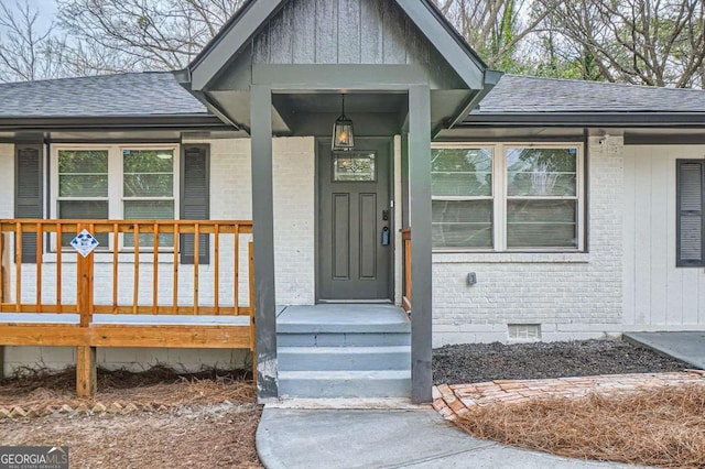 2091 Parker Ranch Rd SE, Atlanta, GA 30316 - view of exterior entry featuring brick siding, board and batten siding, roof with shingles, and crawl space